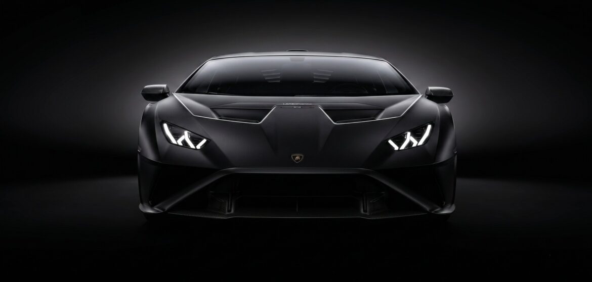 Black Lamborghini with headlights lit - luxury car rental Dubai